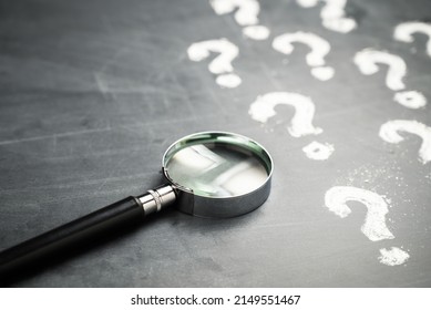 Magnifying Glass Many Question Marks On Stock Photo