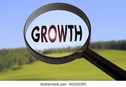 Magnifying Glass Word Growth On Blurred Stock Photo