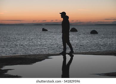 Man Walking Along Shore Sunset Stock Photo Shutterstock