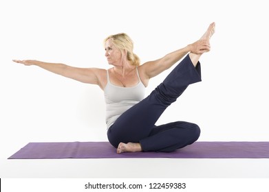 Mature Woman Stretching While Doing Yoga Stock Photo