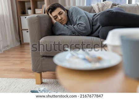 mental health, psychological problem and depression concept - stressed woman lying on sofa at home