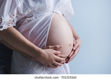 Mother Father Hands Holding Pregnant Belly Stock Photo