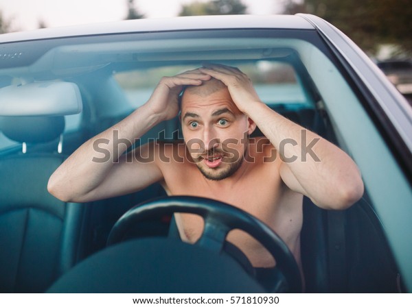 Naked Man In The Car Is In A Traffic Jam