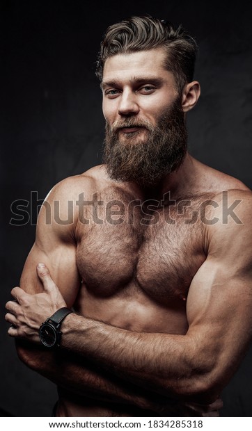 Naked Man With Muscular Build And Beard Posing With Crossed Arms