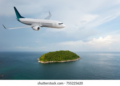 Passenger Airplane Flying Over Above Island Stock Photo