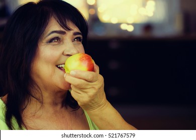 Portrait Happy Mature Woman Eating Apple Stock Photo