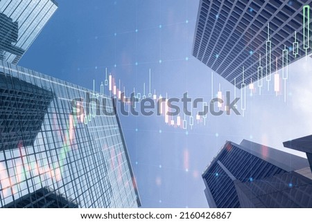 Real estate market growth concept with digital screen with raising stock market candlestick on blue sky and tops of modern skyscrapers background. Double exposure