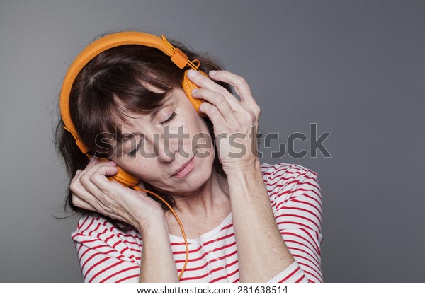 Serene Mature Woman Headphone On Relaxation Stock Photo