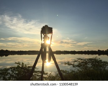 Silhouette Camera On Tripod Shooting Sea Stock Photo