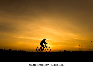 Silhouette Cycling On Sunset Background Stock Photo