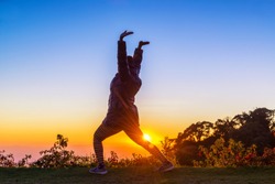 Back View Of A Woman Silhouette Doing Yoga At Sunset A Health