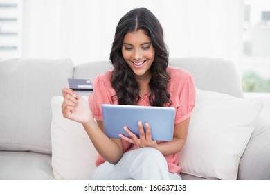 Happy Cute Brunette Sitting On Couch Stock Photo Edit Now