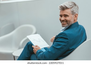 Smiling Mature Businessman Workingon Documents While Stock Photo