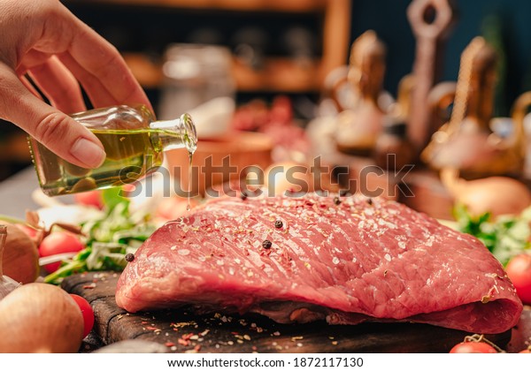 Woman S Hand Seasoning With Extra Virgin Olive Oil And Spices A Veal