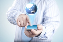 Businessman holding mobile phone with 3D Globe. Concept for connectivity, internet, and communication