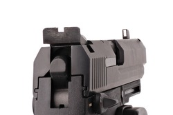 Looking down the barrel of a large 9mm automatic pistol