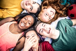 Group of friends laughing out loud outdoor, sharing good and positive mood.