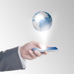 Business man's hand touching on smart phone with glowing digital wire globe