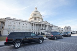 WASHINGTON, DC - JANUARY 20, 2018: Black SUVs parked in front of the United States Capitol on the first day of the government shutdown.
