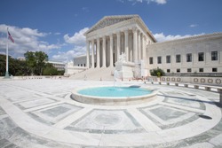 WASHINGTON, DC - AUGUST 20, 2017: A solitary man by the massive steps and pillars at the West Facade of the Supreme Court Building.