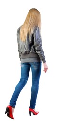 walking blonde girl in motion. during a walk. going woman back view . Rear view people collection. backside view of person. Isolated over white background.
