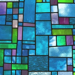 Image of a multicolored stained glass window with irregular block pattern in a hue of blue, square format