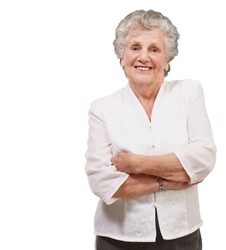 portrait of an adorable senior woman standing over a white background