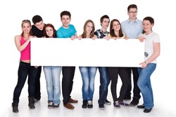 group of cheerful people holding a banner ad isolated over a white background