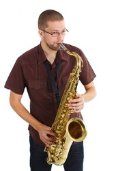 Portrait of a man with glasses, wearing brown shirt, playing the saxophone - isolated on white