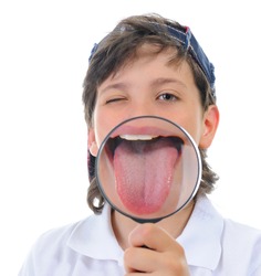 Beautiful boy looking through a magnifying glass isolated on a white background
