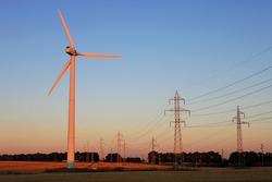 Electricity pylons and wind turbines against sky at sunset Bulgaria, near Kamen Bryag