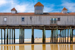 Old Orchard Beach, Maine, historic wooden pier on the sand with reflections