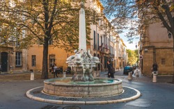 AIX-EN-PROVENCE, FRANCE - OCTOBER 9, 2009: Fountain of Four Dolphins or Fontaine des Quatre-Dauphins, symbol of the Mazarin Quarter, was built in 1667 and was originally called Fontaine Saint-Michel
