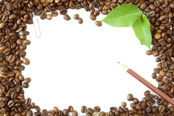 Coffee beans background with wooden pen, fresh green leaves and white blank