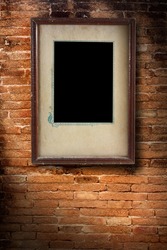 Photo frame on old brick wall texture, grunge industrial interior Uneven diffuse lighting version (Save Paths For design work)