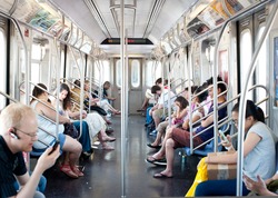 NEW YORK CITY - JUNE 29: Commuters in subway wagon on June 29, 2012 in NYC. The NYC Subway is one of the oldest and most extensive public transportation systems in the world, with 468 stations.
