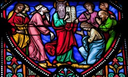 BRUSSELS - JULY 26: Stained glass window depicting Moses and the Stone Tablets with the Ten Commandments in the cathedral of Brussels on July, 26, 2012.