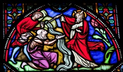 BRUSSELS - JULY 26: Stained glass window depicting Moses striking water from the rock. This window is located in the cathedral of Brussels and was photographed on July, 26, 2012.