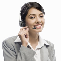 Female customer care executive wearing a headset against a white background