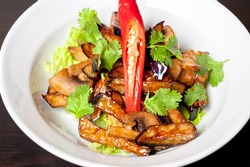 Salad from roasted eggplants, mushrooms, soy sauce, oyster sauce, cilantro and garlic