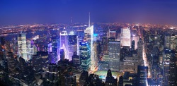 New York City Manhattan Times Square skyline aerial view panorama at night with skyscrapers and street.
