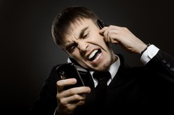 closeup portrait the beautiful businessman careerist in black costume, call and angry cry