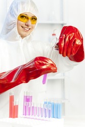 young woman wearing protective coat in laboratory