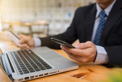 Business man hands using laptop and holding credit card and smart phone with digital layer effect diagram as Online shopping concept