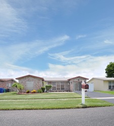 Mailbox on Suburban Neighborhood Street Residential Ranch Style Home Sunny Blue Sky Day