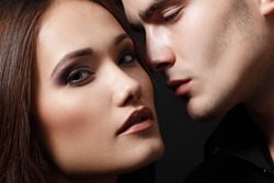 Sexy passion couple, beautiful young female and male faces closeup, studio shot