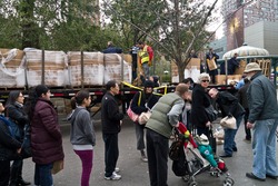 NEW YORK - NOVEMBER 2 People wait in long lines as Con Edison hands out bags of dry ice to customers with no electricity in Union Square Park November 2, 2012 in New York City.