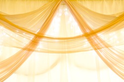golden curtains on a window with illumination