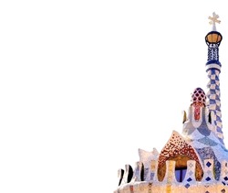 The entrance of Park Guell in Barcelona with the famous mosaics of Antonio Gaudi isolated on white