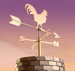 A regular metal weather vane with a cockerel motif facing north on brick chimney against a purple morning sky backdrop